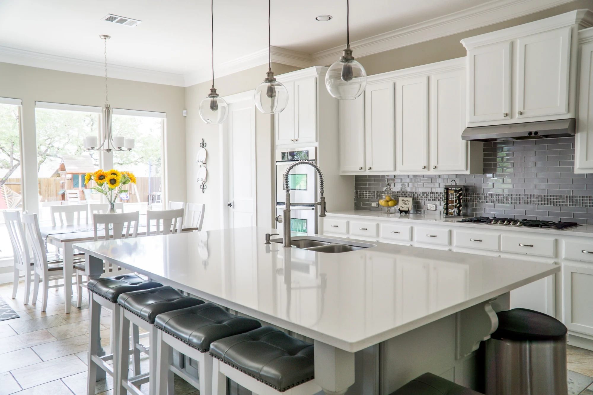 Kitchen inspiration: white cabinets, a large island and glass pendant lights
