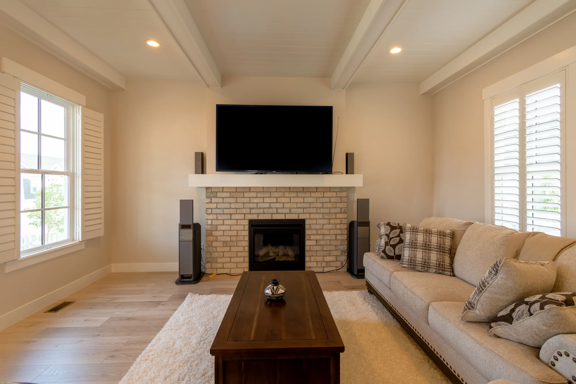 Interior inspiration: cream living room with a brick fireplace and sofa