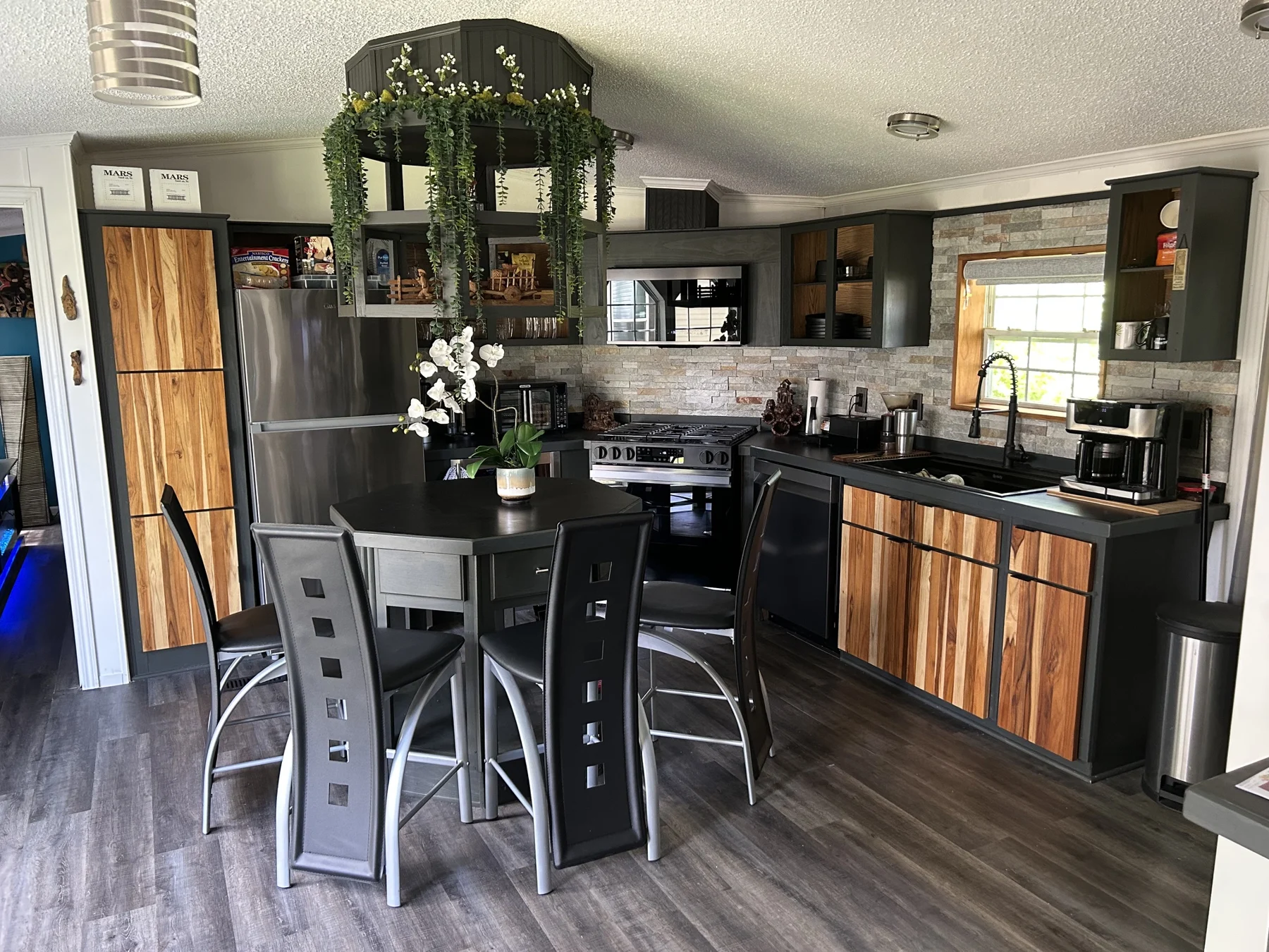 Kitchen with dark cabinetry and a dining area