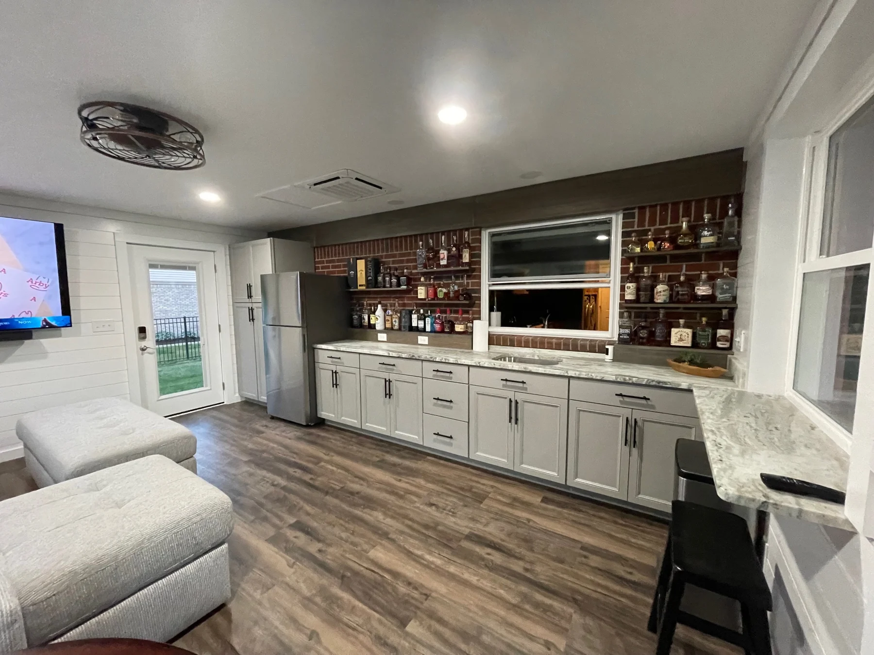 Remodeled interior with built-in cabinetry and wood-look flooring